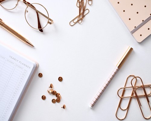 A warm lit desk with workspace utilities representing structured editorial operations